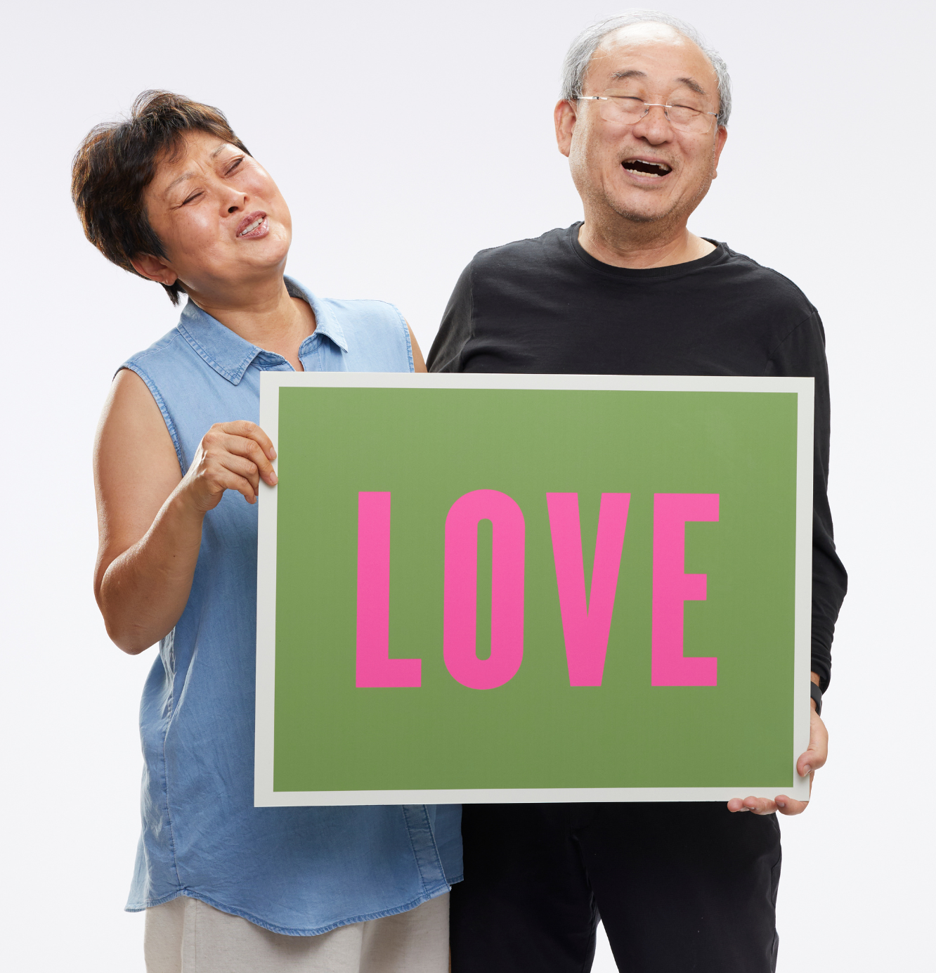 Couple holding Freedom to Thrive love sign