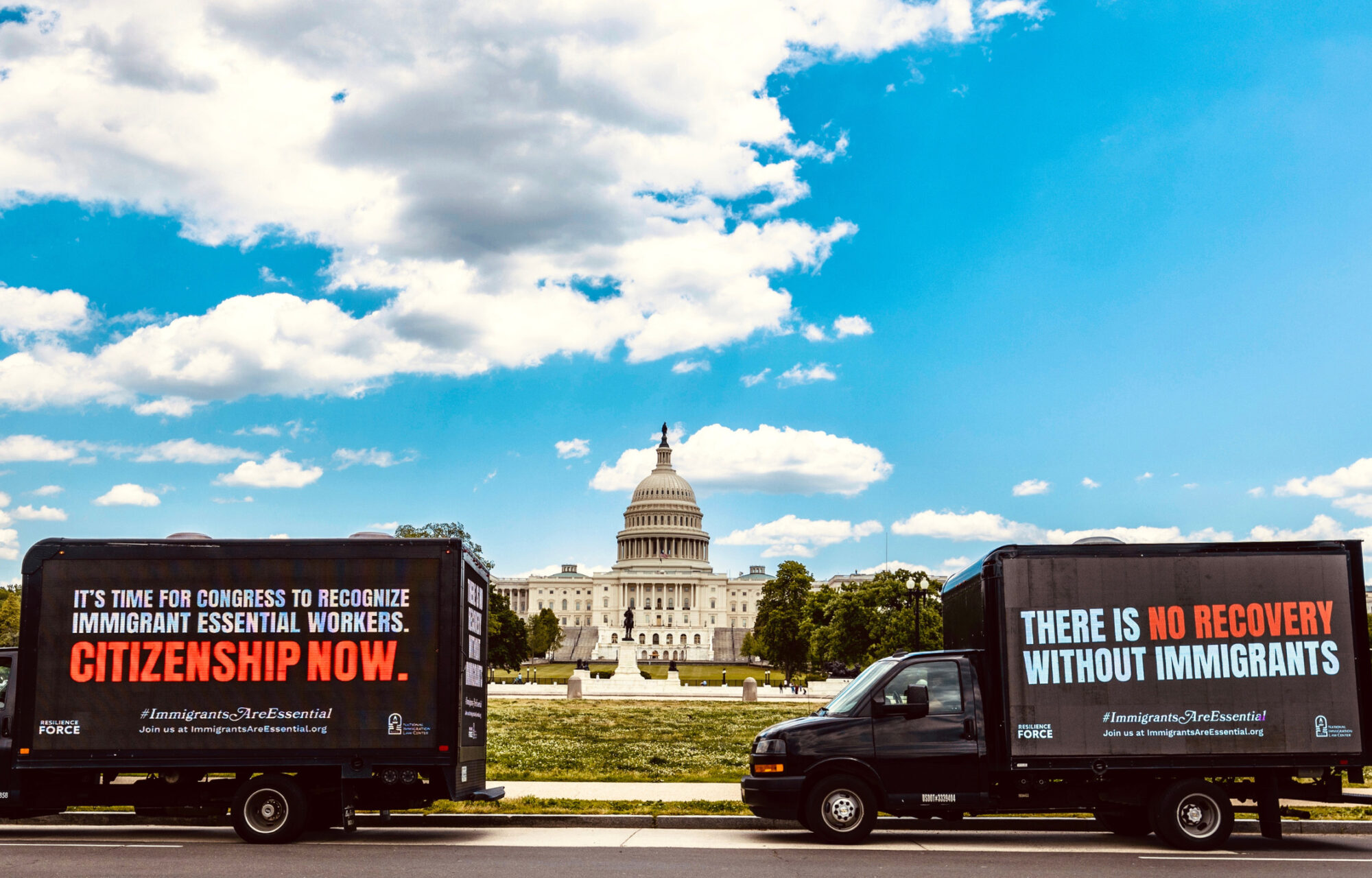 Two trucks sitting in front of the U.S. capitol with digital ads, reading 
